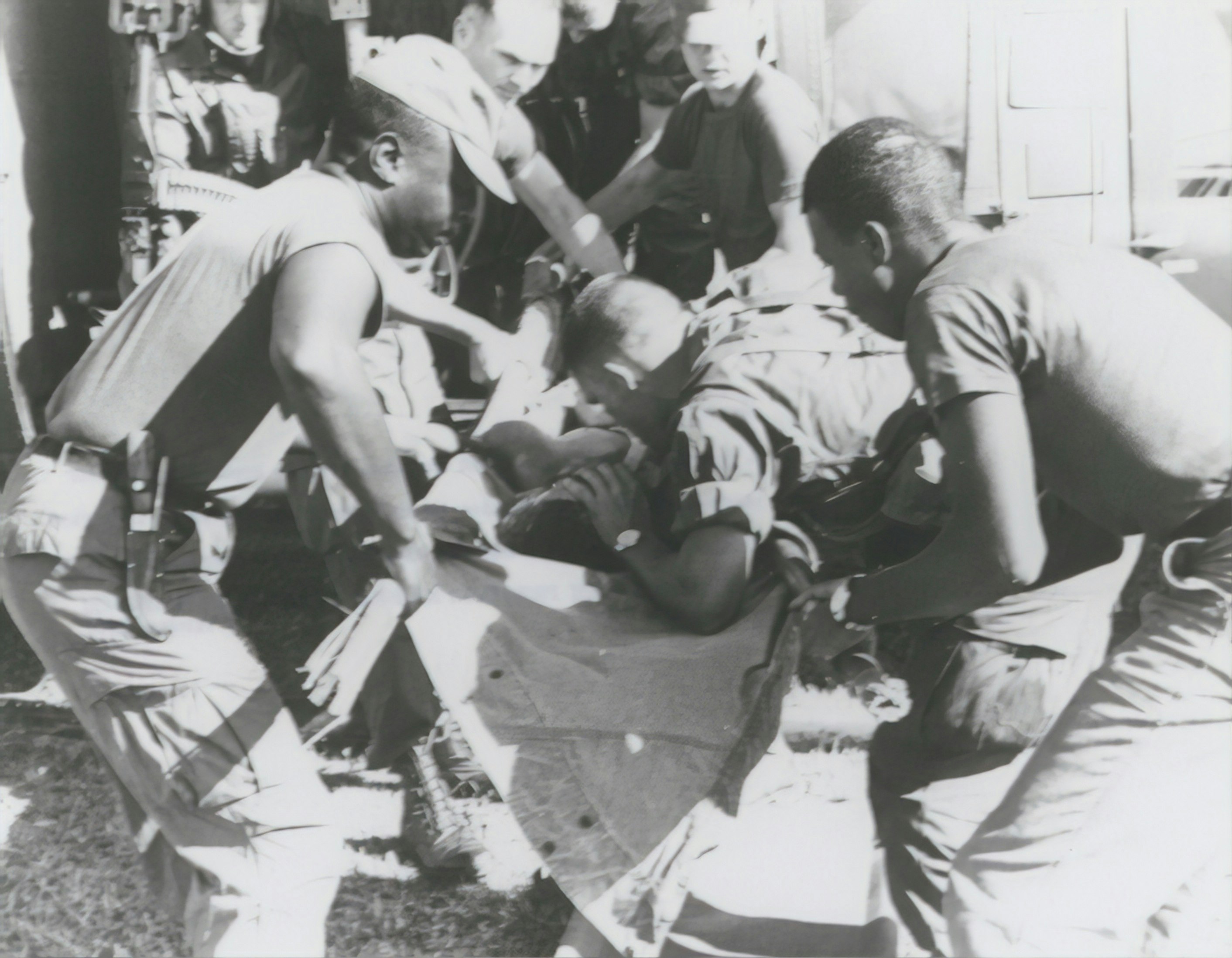 grayscale photography of man carrying another man